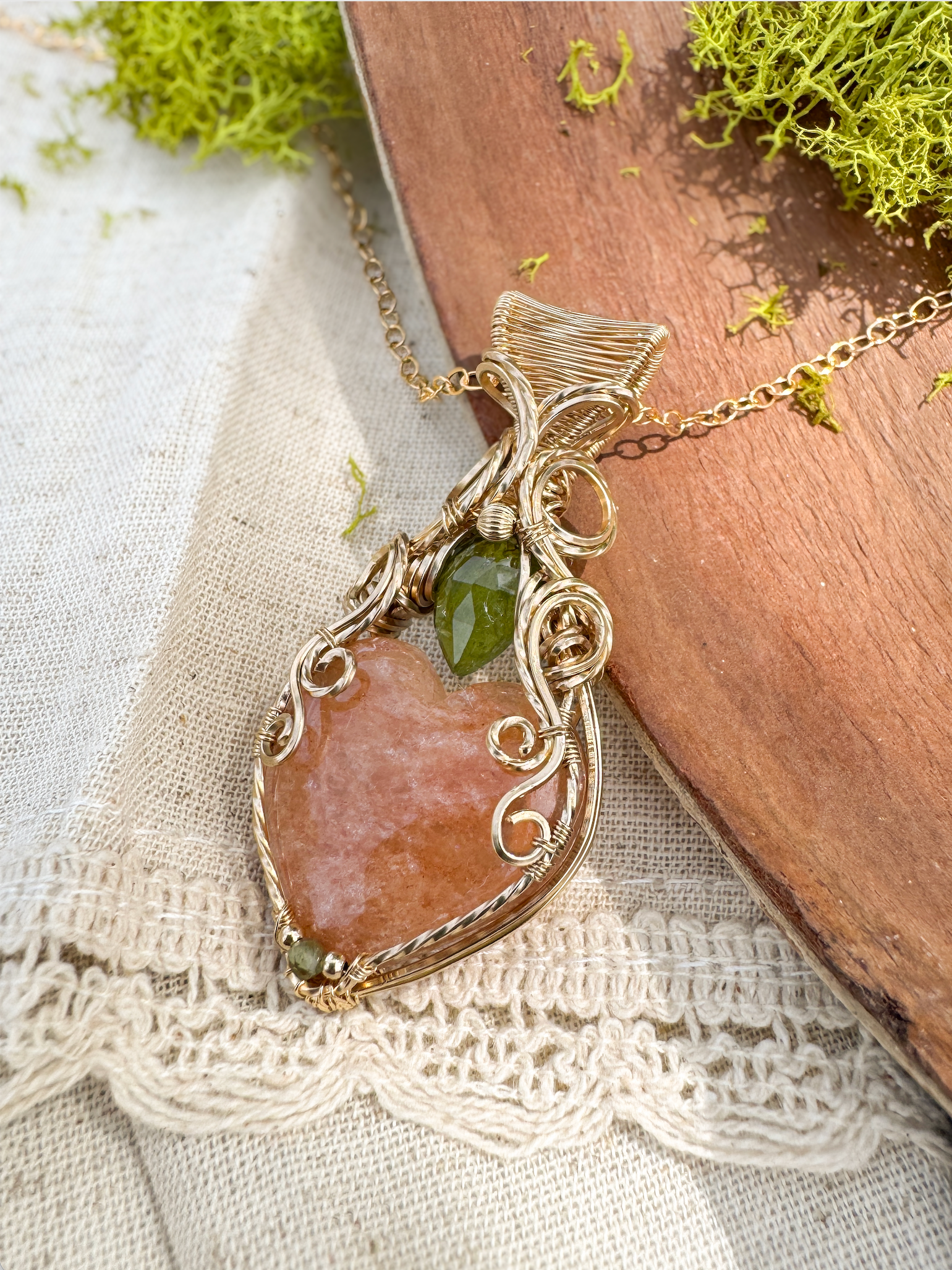 Necklace with a large brown stone pendant on a textured fabric background